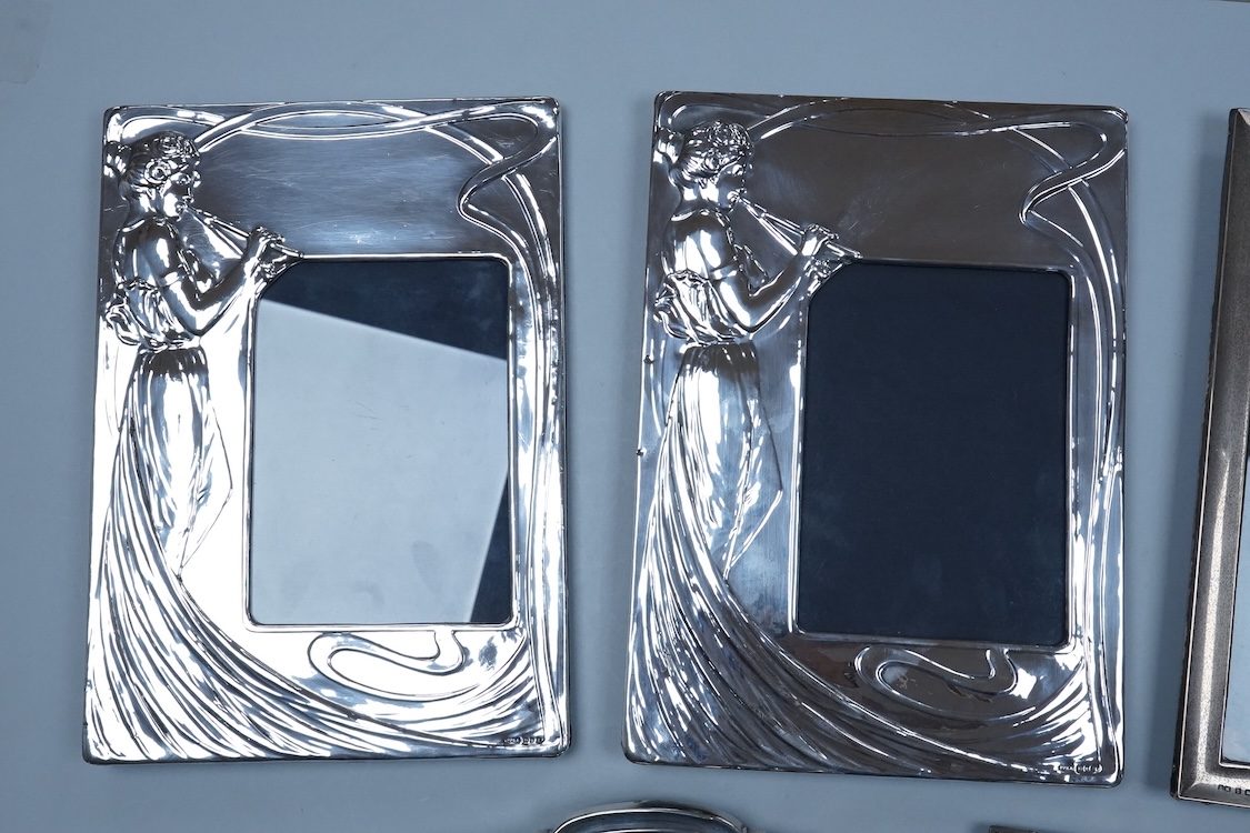Three assorted George V silver mounted photograph frames, largest 23.9cm by 18.2cm, together with a pair of modern Art Nouveau style silver mounted photograph frames, PP & A, London, 1981.